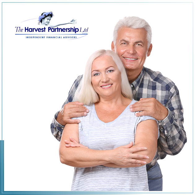 A picture of happy retirees smiling for the camera against a white background.